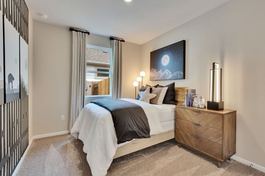A bedroom with a bed and a dresser. A bedroom with a bed and a dresser.