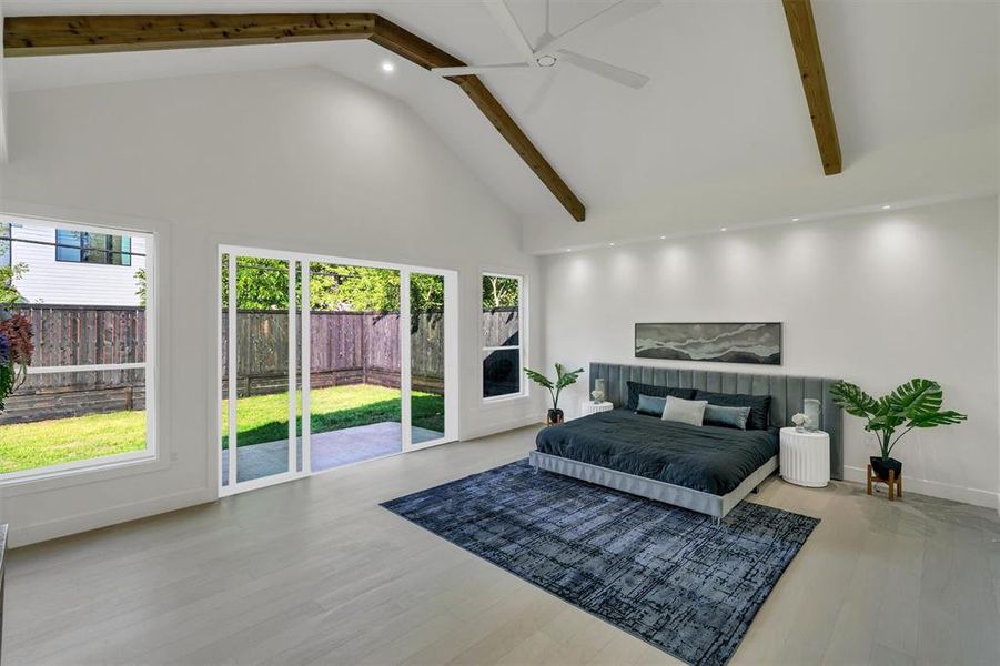 Bedroom with a ceiling fan, beamed ceiling, wood finished floors, access to exterior, and high vaulted ceiling