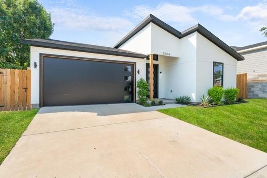 Contemporary house with concrete driveway, stucco siding, and a garage Contemporary house with concrete driveway, stucco siding, and a garage