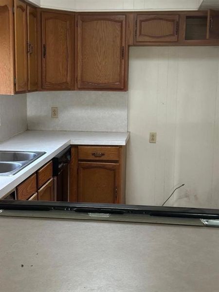 Kitchen featuring brown cabinets and light countertops