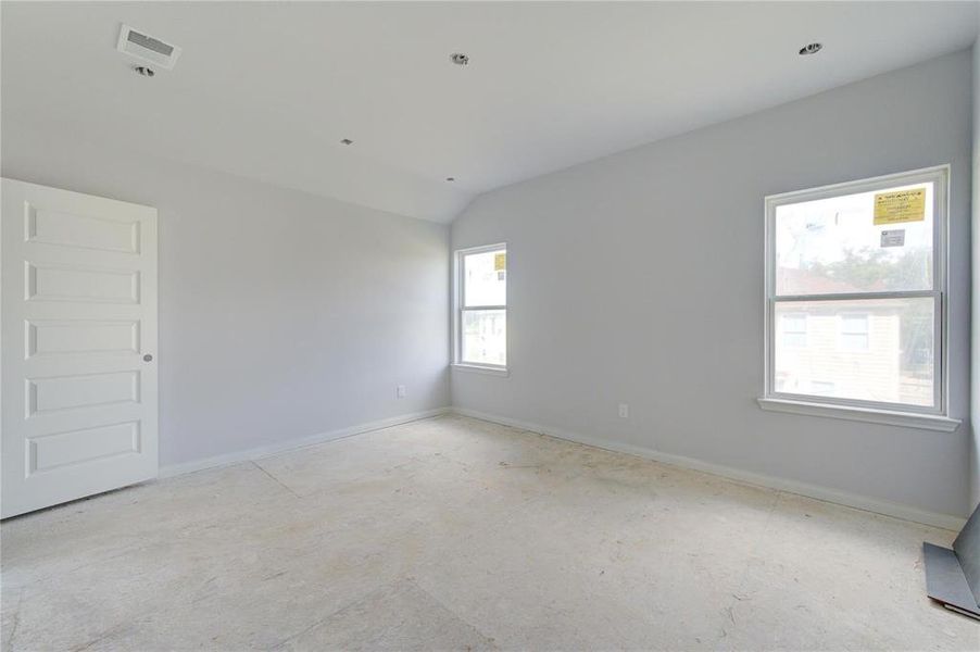 This spacious primary bedroom, bathed in natural light from large windows, provides the perfect blank canvas for creating a cozy retreat. The neutral palette allows for personalized touches that will make this room truly yours. **This image is from another Saratoga Home - Athena floorplan.**