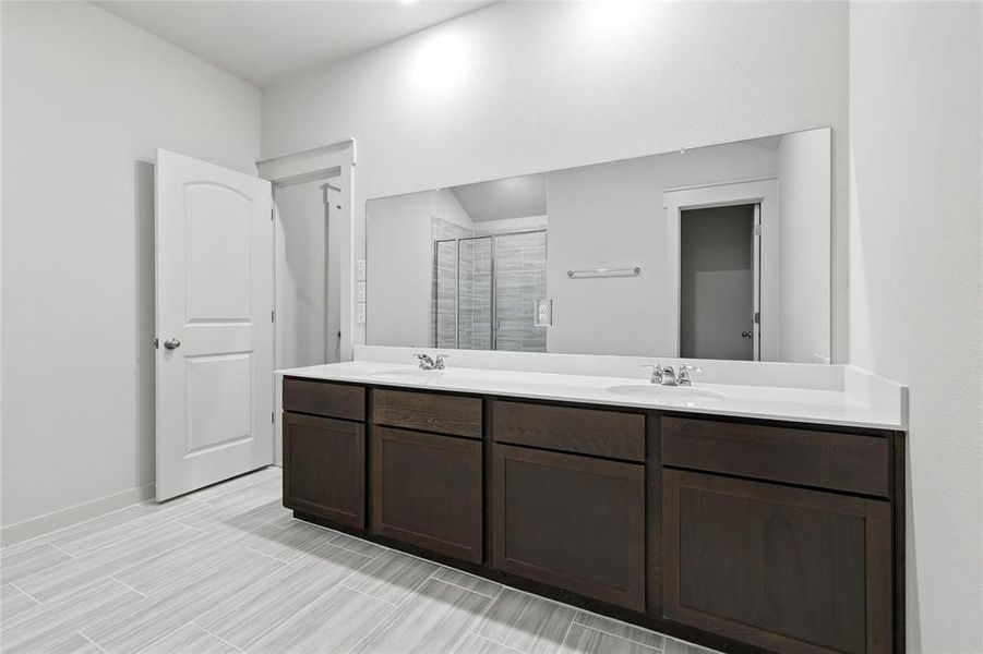 Bathroom with double vanity and a shower stall Bathroom with double vanity and a shower stall
