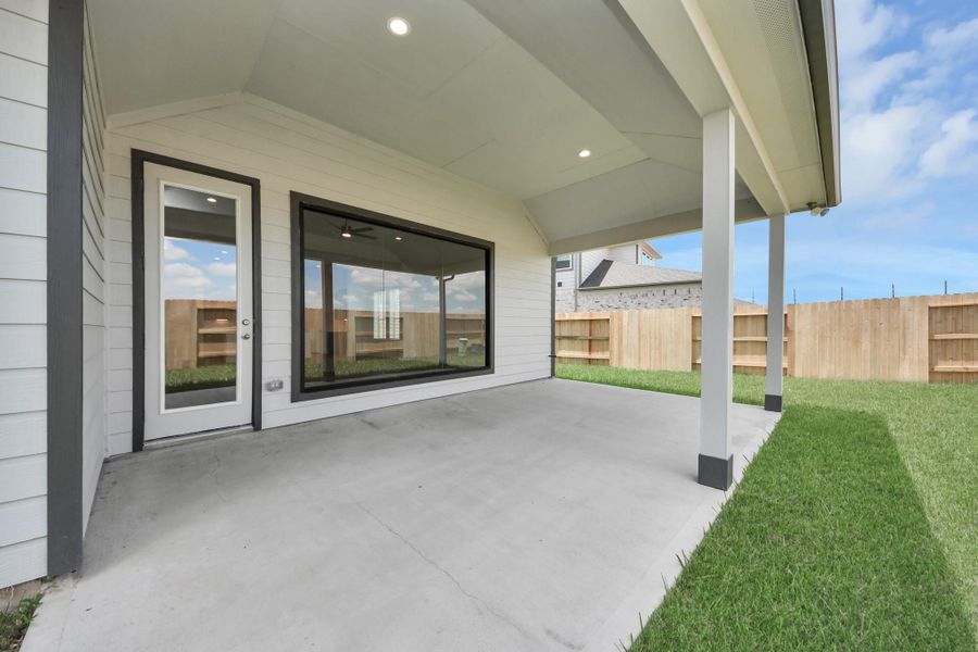 Experience outdoor living at its finest on this expansive covered patio, thoughtfully designed for BBQs and delightful outdoor dining.