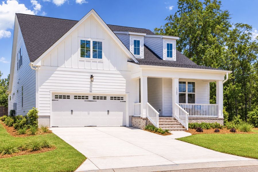 Front exterior of a new home in Sunset Reach, Castle Hayne, NC, highlighting curb appeal (Image 1). Front exterior of a new home in Sunset Reach, Castle Hayne, NC, highlighting curb appeal (Image 1).