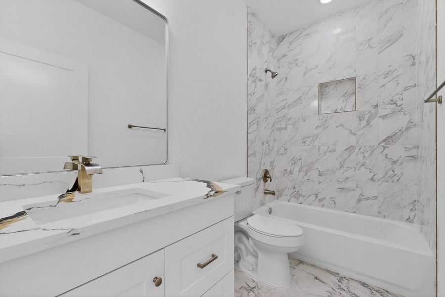 Bathroom with vanity, shower / tub combination