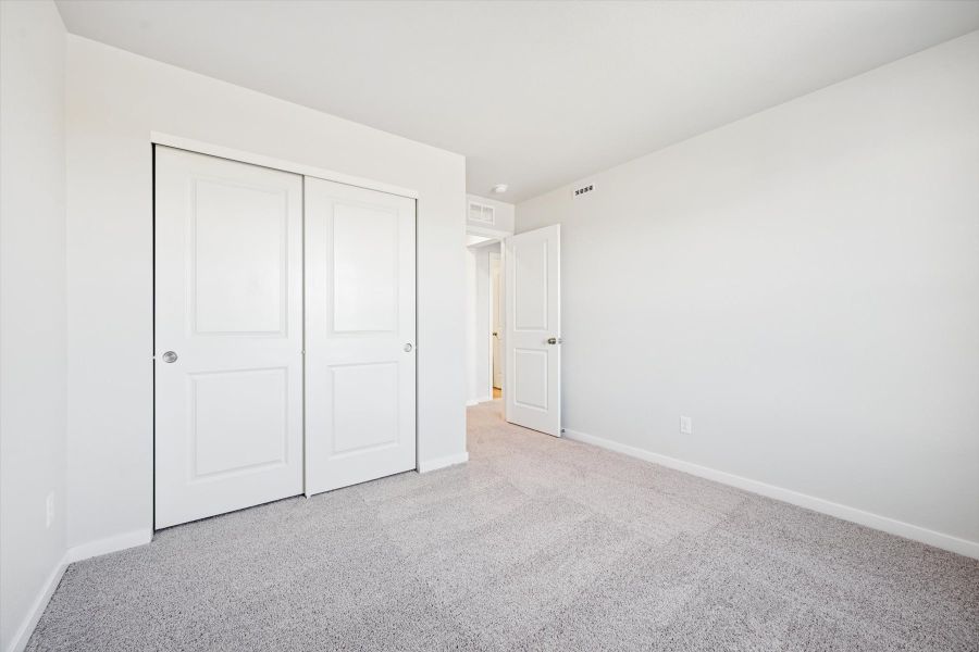 A hallway with white doors.