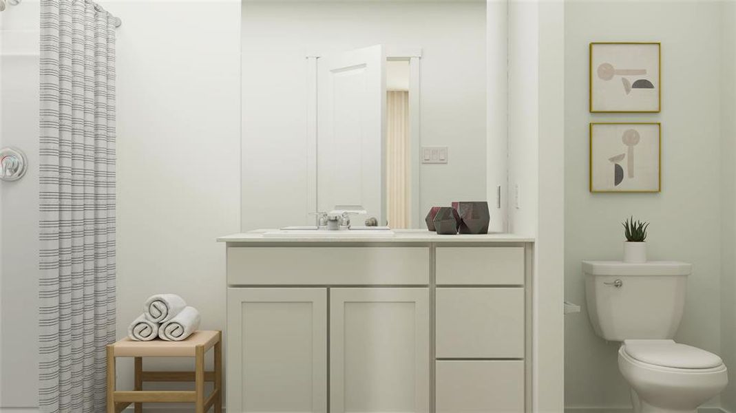 Bathroom featuring curtained shower, vanity, and toilet