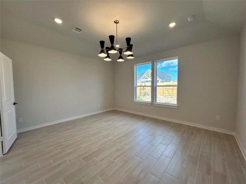 Main bedroom features an elegant chandelier with high ceilings.