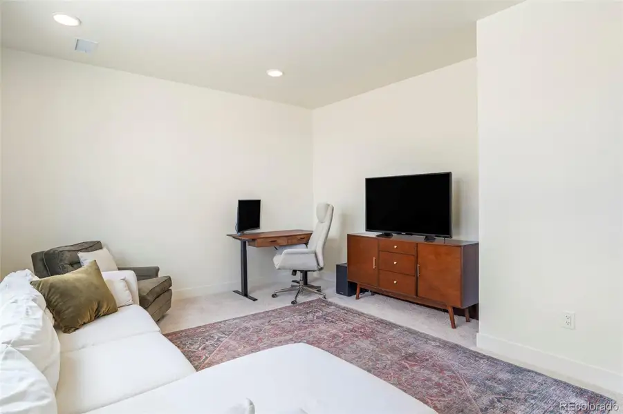 Spacious upper-level loft with flexible layout, ideal for lounging, working, or additional living space in this Morrison home near Red Rocks