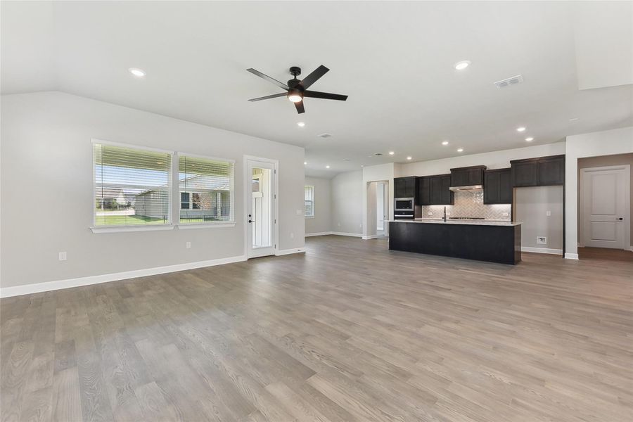 Unfurnished living room featuring ceiling fan, light wood finished floors, baseboards, and recessed lighting Unfurnished living room featuring ceiling fan, light wood finished floors, baseboards, and recessed lighting