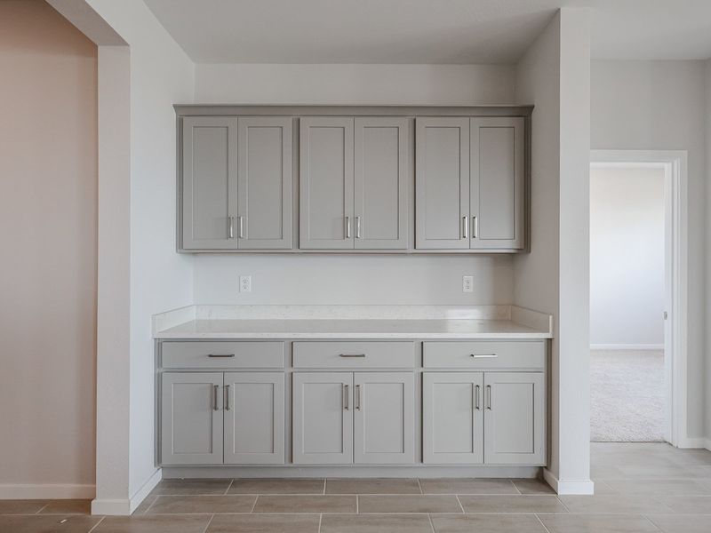 A kitchen with white cabinets.