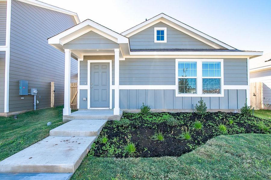 Front exterior of a new home in Bastrop Grove: Stonehill Collection, Bastrop, TX, highlighting curb appeal (Image 14).
