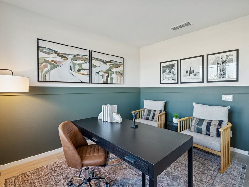 A living room with a table and chairs.