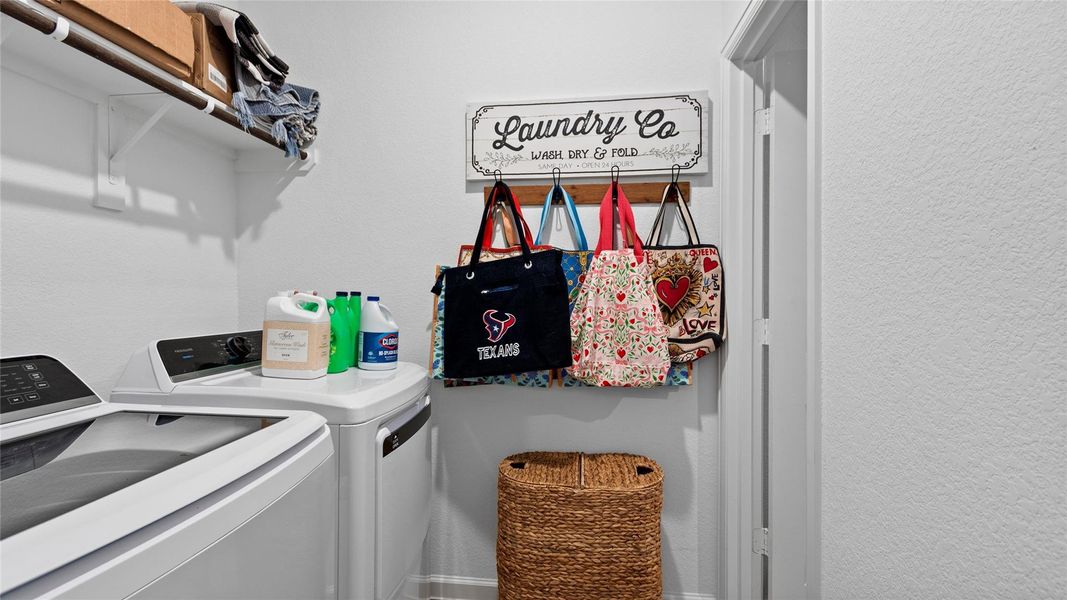Designed for everyday convenience, the functional laundry room offers dual access from the garage entry and primary suite, providing flexibility and ease of use. Designed for everyday convenience, the functional laundry room offers dual access from the garage entry and primary suite, providing flexibility and ease of use.