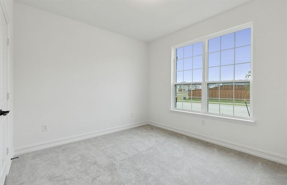 Spacious secondary bedroom with ample closet space *real home pictured