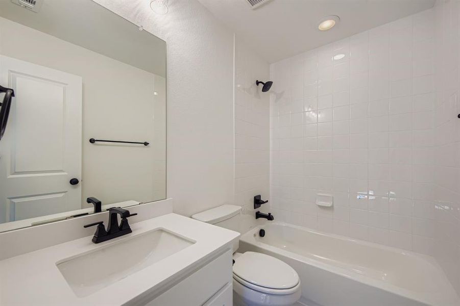 Full bath featuring vanity, shower / bath combination, and recessed lighting