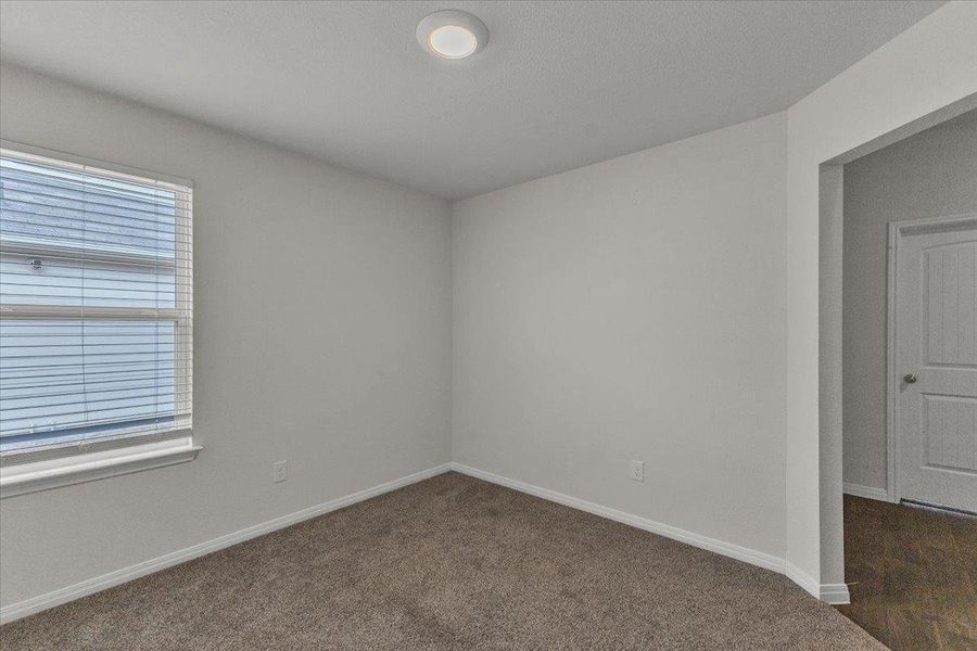 The property features light gray walls, a window with blinds, and recessed lighting