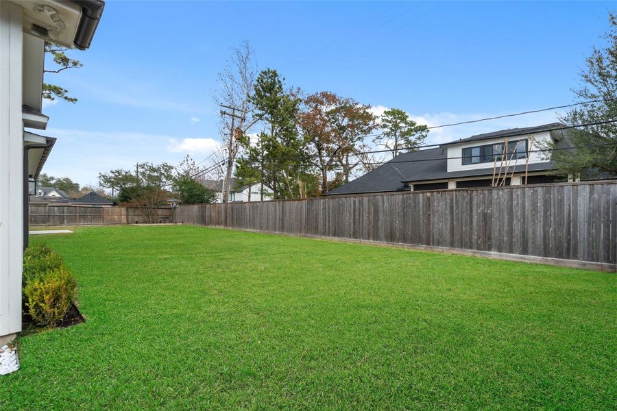 The backyard offers plenty of room for play and entertaining.