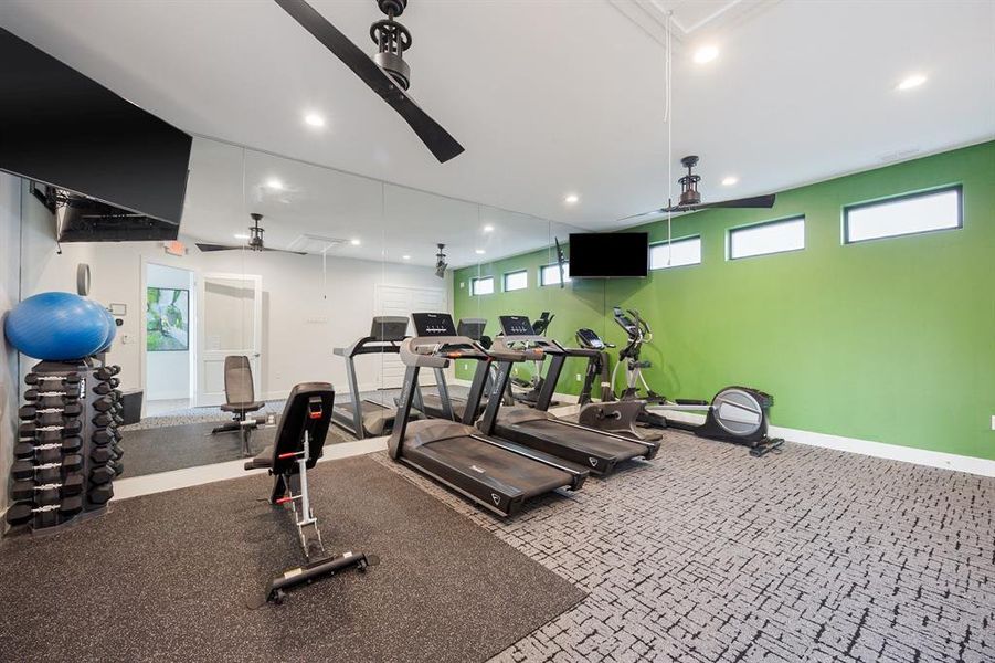 Gym in clubhouse featuring exercise equipment