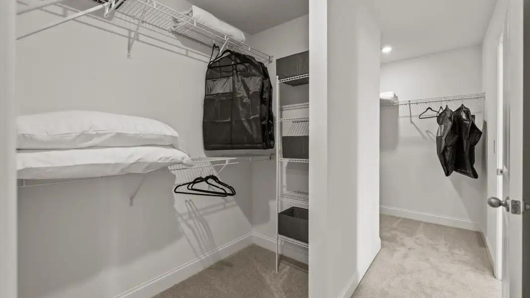 Large dual walk-in closets with elevated ceiling and plush carpeting in the Townsend Design by DRB Homes in York, SC Large dual walk-in closets with elevated ceiling and plush carpeting in the Townsend Design by DRB Homes in York, SC