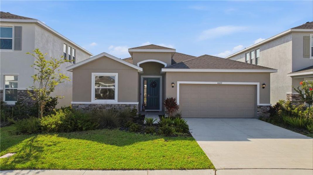 Front exterior of a new home in Bella Lago, Parrish, FL, highlighting curb appeal (Image 25). Front exterior of a new home in Bella Lago, Parrish, FL, highlighting curb appeal (Image 25).