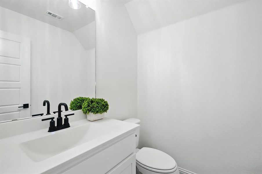 Upstairs half bath next to the media room.