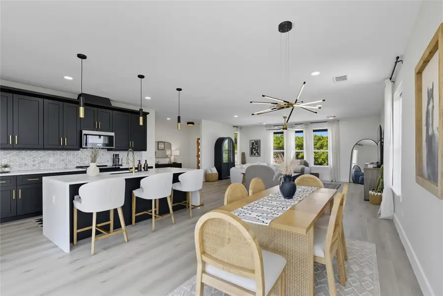 Dining room featuring light wood finished floors, recessed lighting, and arched walkways