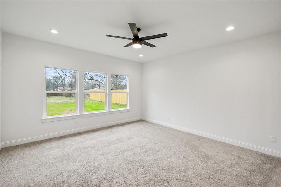 Spare room featuring carpet floors, baseboards, and recessed lighting