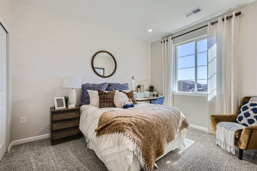 A bedroom with a bed and a mirror. A bedroom with a bed and a mirror.