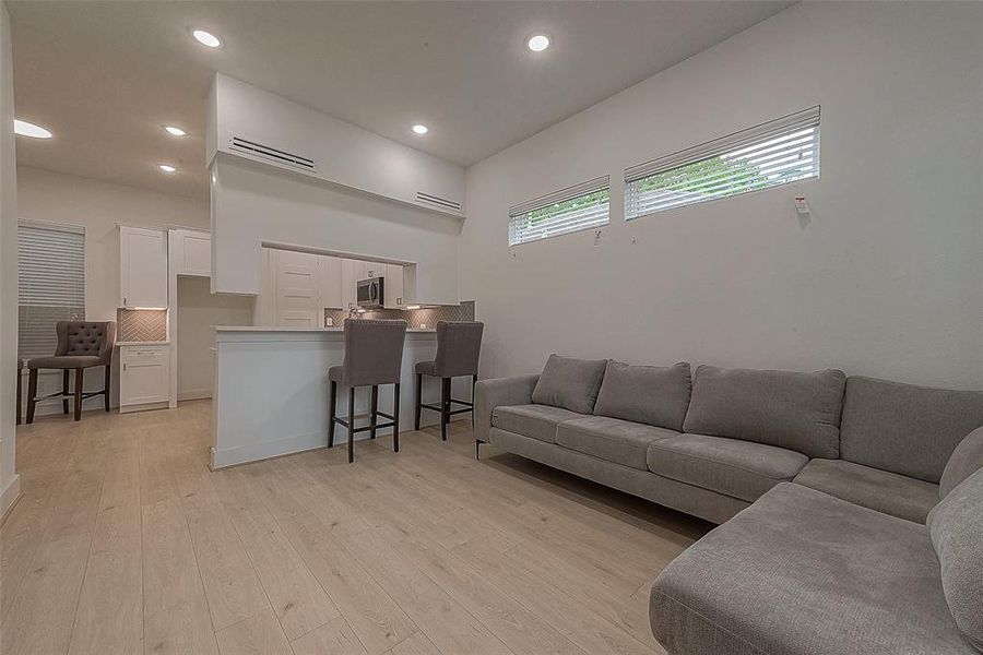 The open floor plan with neutral colors is accented by the luxury vinyl plank flooring throughout the home. Home has no carpet.