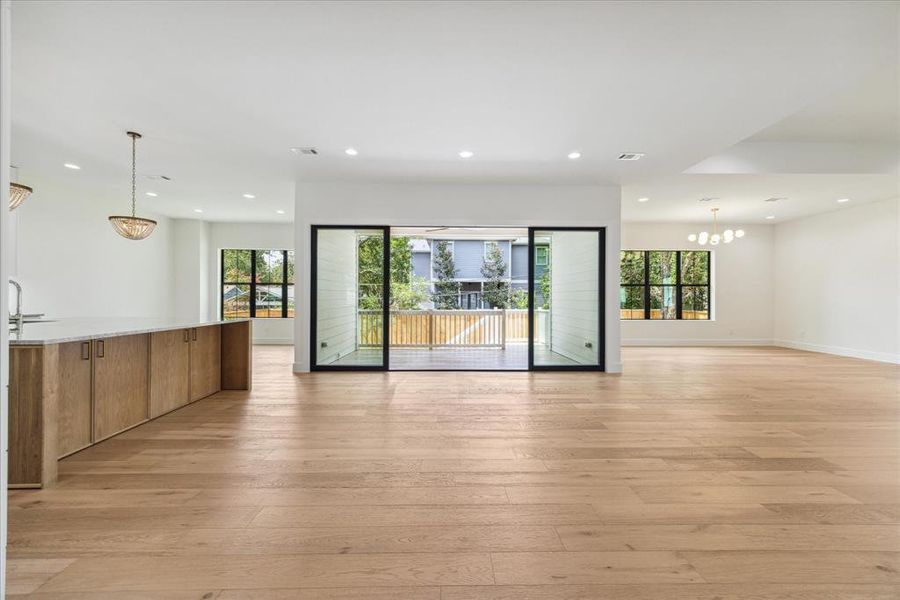 An open-concept floor plan showcases the seamless connectivity between the breakfast room, kitchen, family room, and formal dining room, all with easy access to the covered patio.