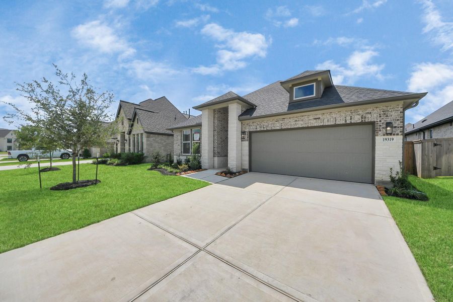 Front exterior of a new home in Amira: Heritage Collection, Tomball, TX, highlighting curb appeal (Image 2). Front exterior of a new home in Amira: Heritage Collection, Tomball, TX, highlighting curb appeal (Image 2).