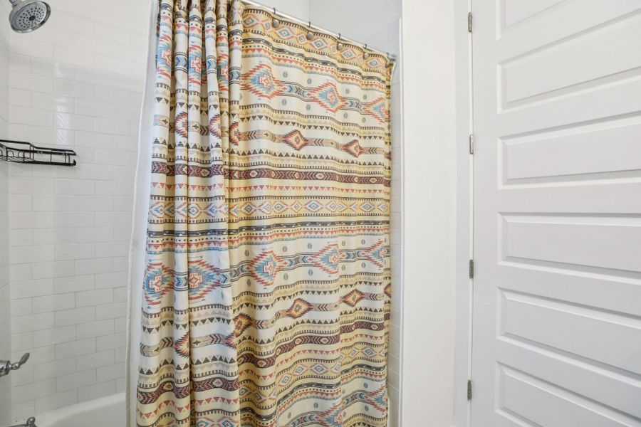 Bathroom featuring shower / bath combo with shower curtain Bathroom featuring shower / bath combo with shower curtain
