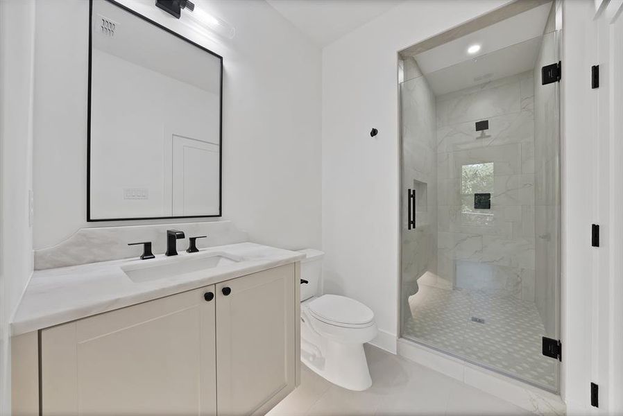 Contemporary bathroom featuring a frameless glass shower enclosure