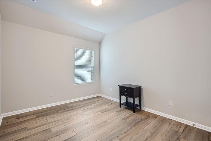 A large spare bedroom with plenty of room for a queen bed and other furniture.  Notice the lovely flooring in the bedrooms?  No carpet!!