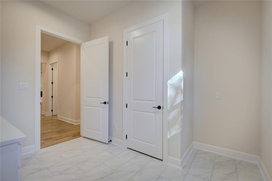 Laundry has space for a freezer plus a storage closet.