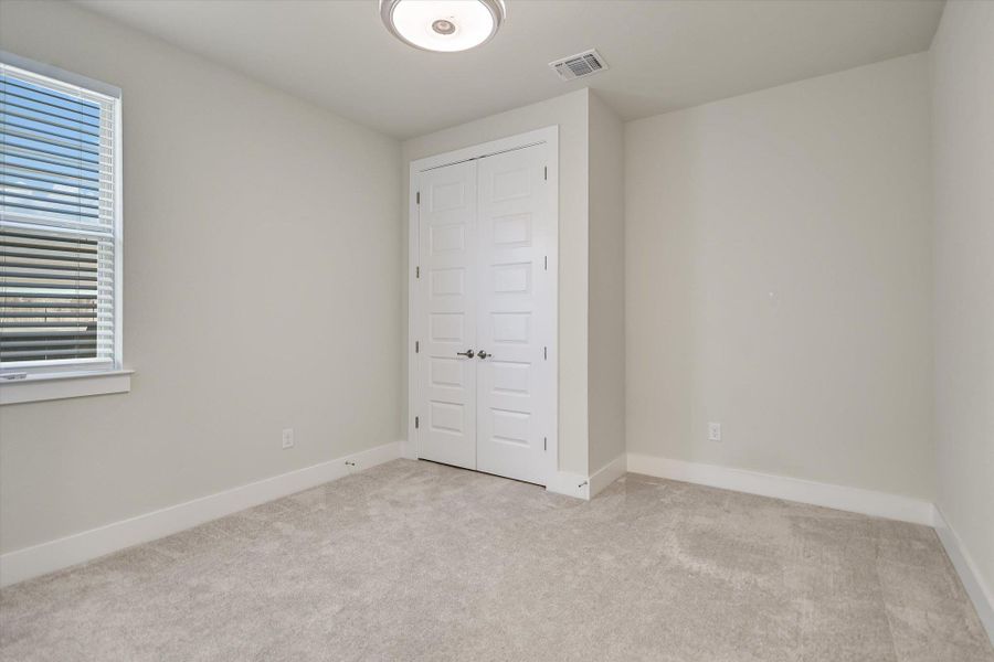 Plush carpeting pairs with clean white trim under a neutral color palette. Plush carpeting pairs with clean white trim under a neutral color palette.