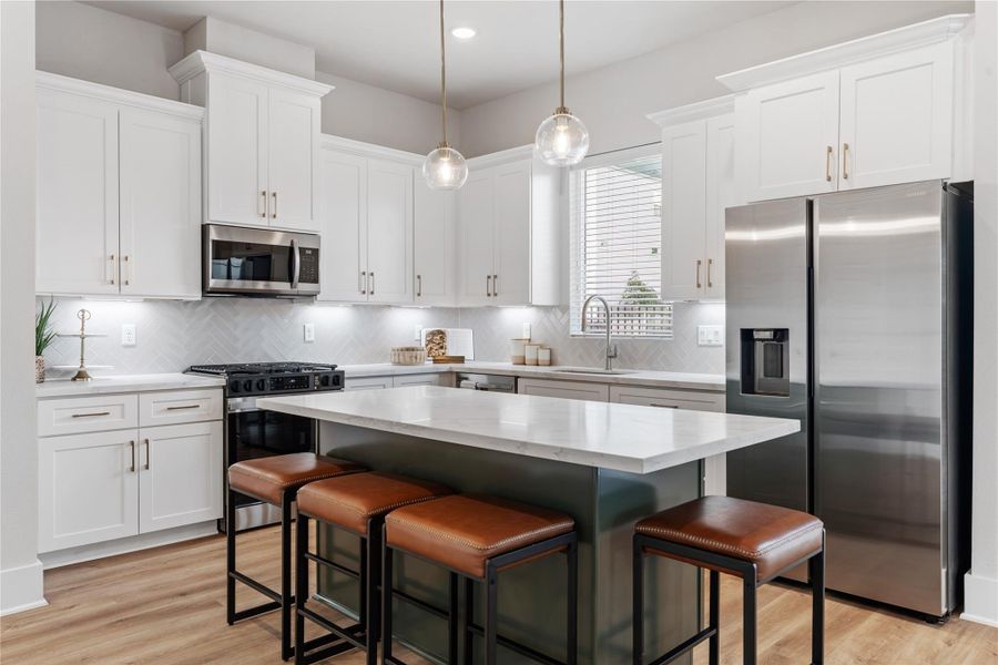 A well-balanced kitchen and dining space defined by thoughtful contrast, functional layout, and subtle design details that elevate everyday living.