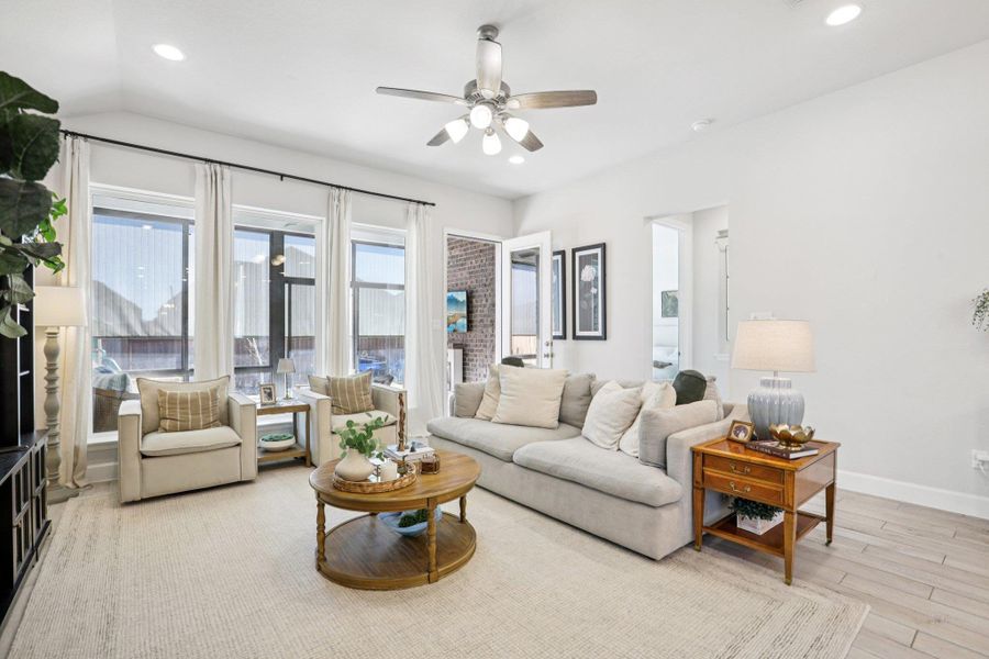 Living room featuring a ceiling fan, recessed lighting, and light wood-type flooring