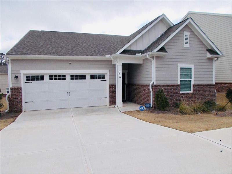Front exterior of a new home in Ashford Park, Covington, GA, highlighting curb appeal (Image 22).