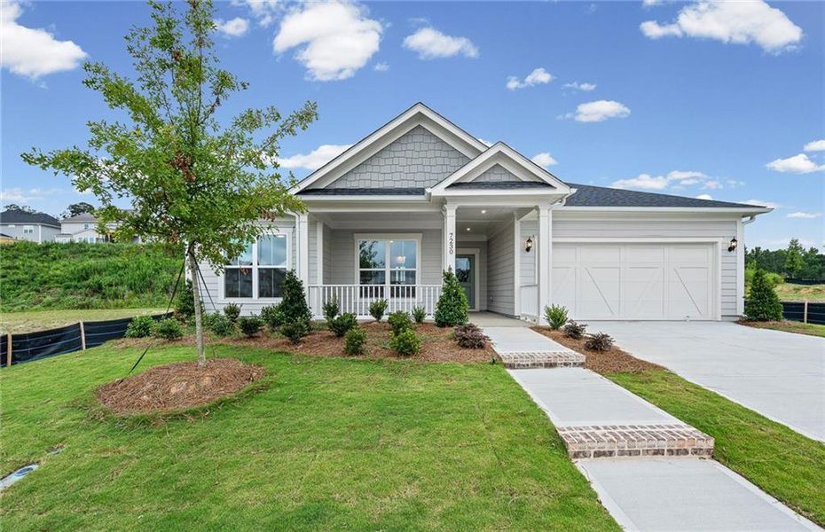 Front exterior of a new home in Reunion, Flowery Branch, GA, highlighting curb appeal (Image 1). Front exterior of a new home in Reunion, Flowery Branch, GA, highlighting curb appeal (Image 1).