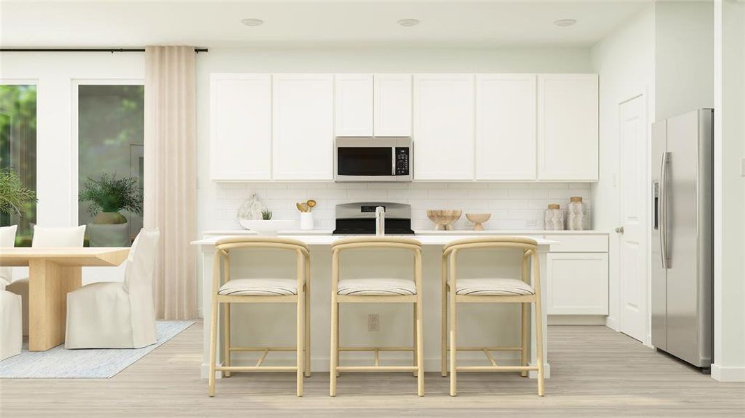 Kitchen with stainless steel appliances, white cabinets, backsplash, a breakfast bar, and light wood-type flooring