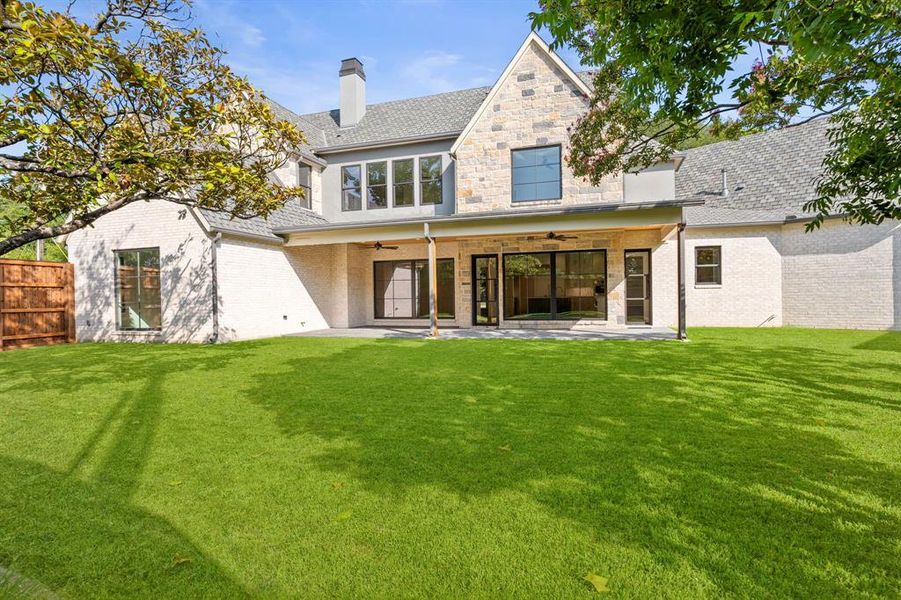 Rear view of property with a ceiling fan, a patio, a chimney, and brick siding Rear view of property with a ceiling fan, a patio, a chimney, and brick siding
