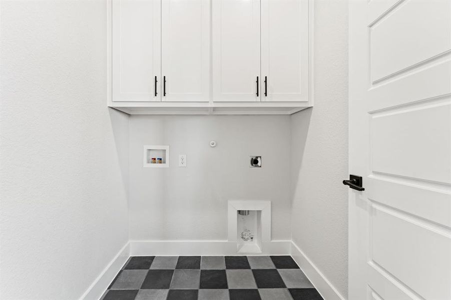 Laundry area with hookup for an electric dryer, washer hookup, gas dryer hookup, and cabinets