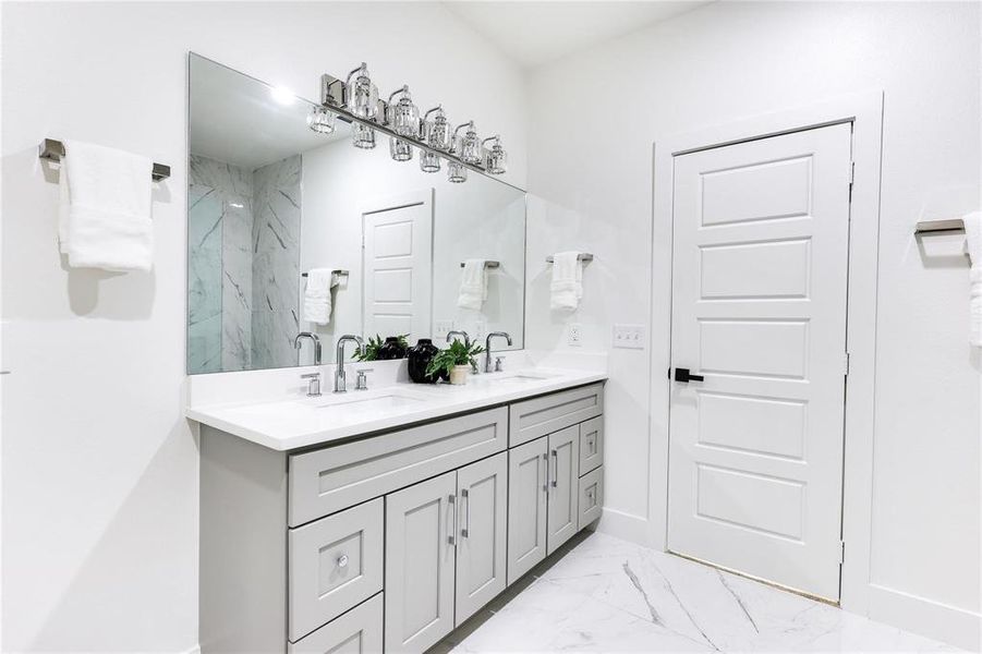 Bathroom featuring vanity and tiled shower