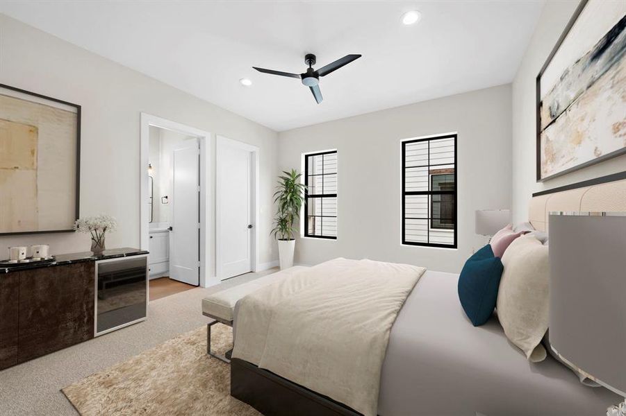 A secondary bedroom suite located on the second floor. High end carpet and walk-in closet wrapped in built-in storage. Furniture shown in photo is virtually staged.