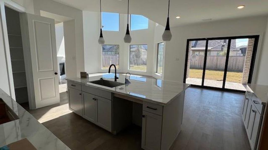 Upgraded state of the art kitchen Offers stacked cabinets and porcelain countertops. Sliders have been added in just the right space. This makes it easy for family or guests to travel in and out.