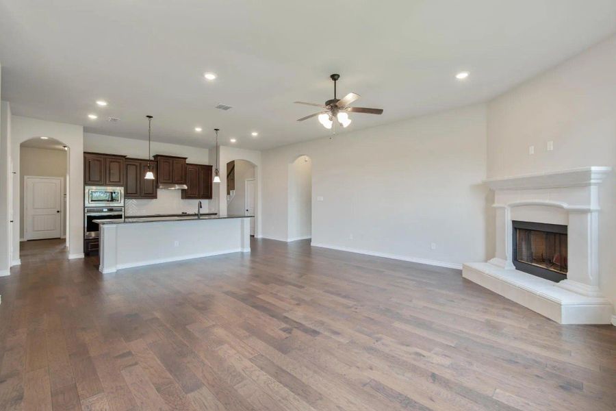 Family Room & Kitchen | Concept 2671 at Mockingbird Hills in Joshua, TX by Landsea Homes