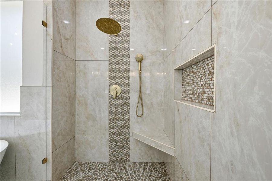 Bathroom featuring a tile shower and a freestanding bath