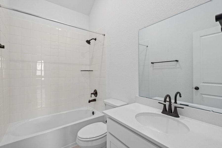 The secondary bath features tile flooring, white cabinetry and light countertops and a shower/tub combo. Perfect for accommodating any visiting family and friends. The secondary bath features tile flooring, white cabinetry and light countertops and a shower/tub combo. Perfect for accommodating any visiting family and friends.